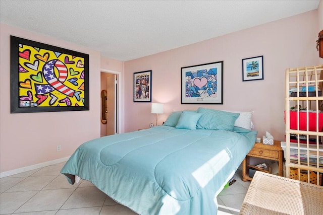 1009 N Ocean Blvd Unit 510, Pompano Beach, FL 33062 - bedroom with light tile patterned floors, a textured ceiling, and baseboards