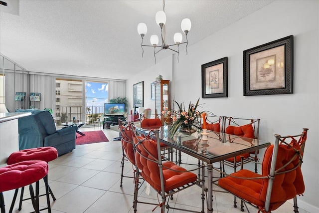 1009 N Ocean Blvd Unit 510, Pompano Beach, FL 33062 - dining space featuring a textured ceiling, a chandelier, and light tile patterned floors