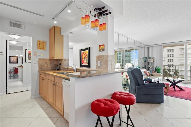 1009 N Ocean Blvd Unit 510, Pompano Beach, FL 33062 - kitchen with a sink, tasteful backsplash, open floor plan, light tile patterned floors, and expansive windows
