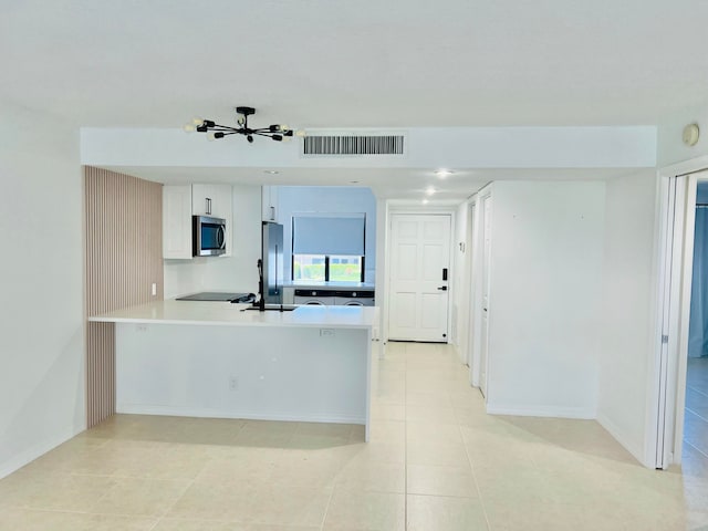 4236 Deste Ct Unit 208, Lake Worth, FL 33467 - kitchen with appliances with stainless steel finishes, light countertops, a peninsula, light tile patterned floors, and baseboards