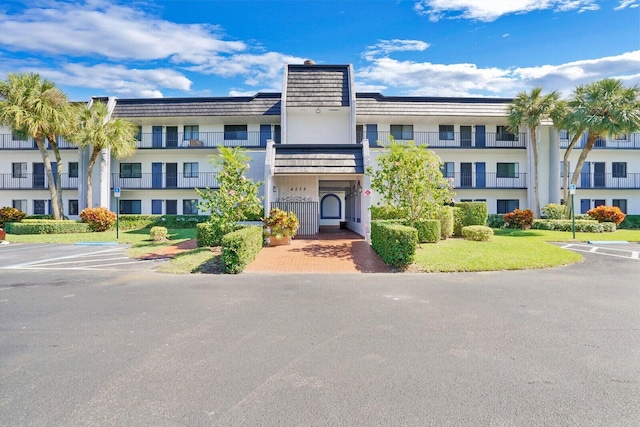 4236 Deste Ct Unit 208, Lake Worth, FL 33467 - view of building exterior featuring uncovered parking
