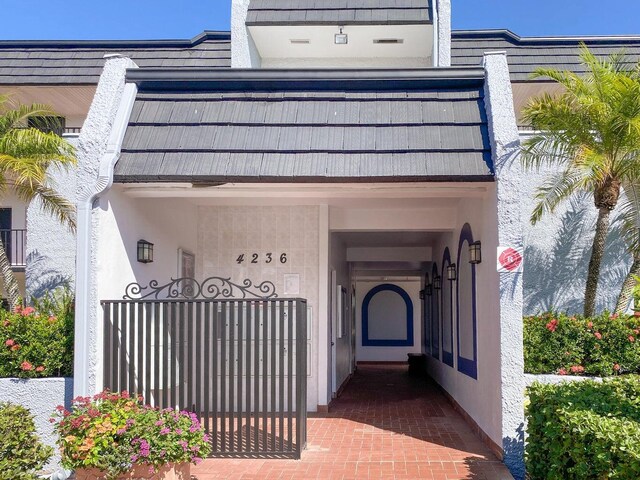 4236 Deste Ct Unit 208, Lake Worth, FL 33467 - view of exterior entry featuring stucco siding