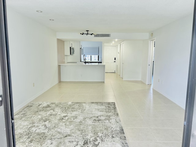 4236 Deste Ct Unit 208, Lake Worth, FL 33467 - unfurnished living room featuring light tile patterned floors, a sink, recessed lighting, and baseboards