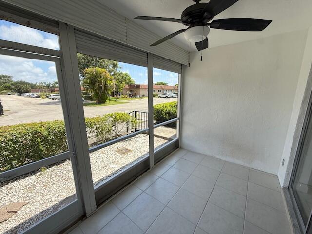 1906 Palmland Dr Unit D, Boynton Beach, FL 33436 - unfurnished sunroom featuring a ceiling fan