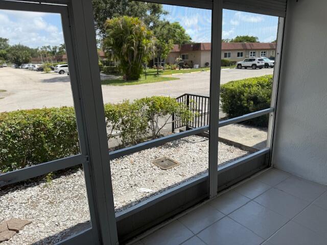 1906 Palmland Dr Unit D, Boynton Beach, FL 33436 - doorway featuring tile patterned flooring and a residential view