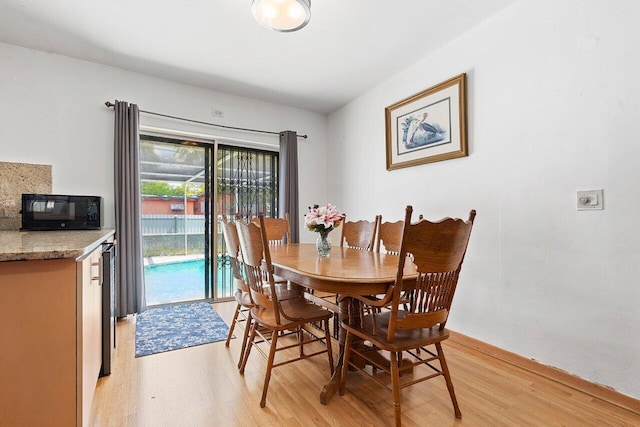 1045 NW 47th Ter, Miami, FL 33127 - dining area featuring light wood finished floors and baseboards