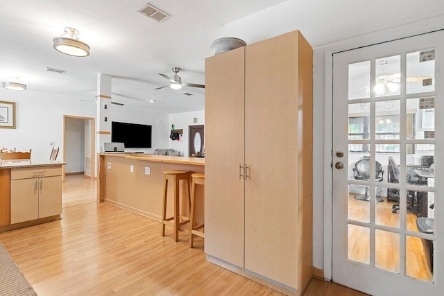 1045 NW 47th Ter, Miami, FL 33127 - kitchen featuring ceiling fan, light wood-style floors, and light countertops