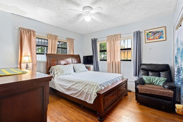 1045 NW 47th Ter, Miami, FL 33127 - bedroom with a textured ceiling, wood finished floors, and ceiling fan