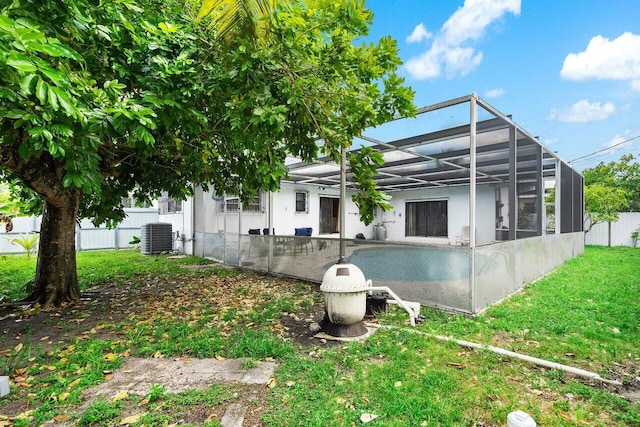 1045 NW 47th Ter, Miami, FL 33127 - back of house with central AC unit and a lanai