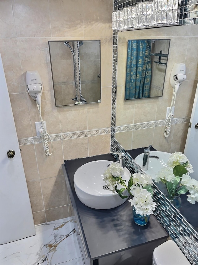19201 Collins Ave Unit 337, Sunny Isles Beach, FL 33160 - bathroom featuring tile walls, vanity, marble finish flooring, and toilet