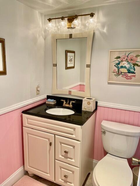 577 Mansfield N N Unit 577, Boca Raton, FL 33434 - bathroom featuring vanity, a wainscoted wall, and toilet