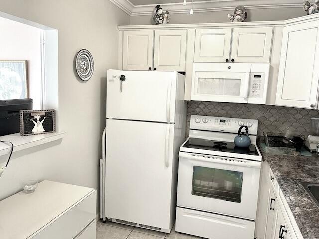 577 Mansfield N N Unit 577, Boca Raton, FL 33434 - kitchen featuring white appliances, ornamental molding, backsplash, white cabinets, and light tile patterned floors