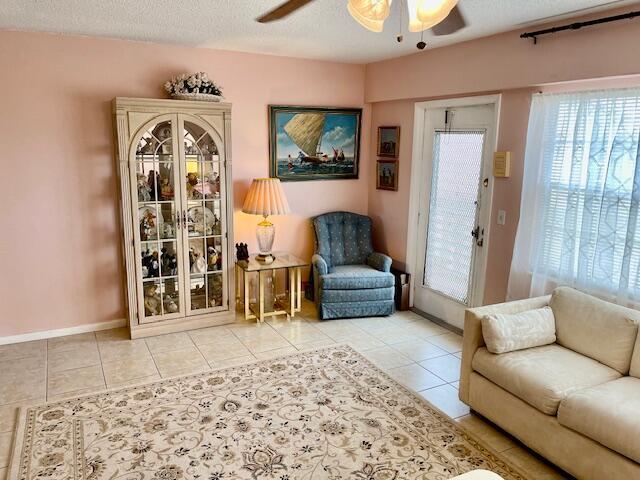 577 Mansfield N N Unit 577, Boca Raton, FL 33434 - tiled living area featuring a ceiling fan and baseboards