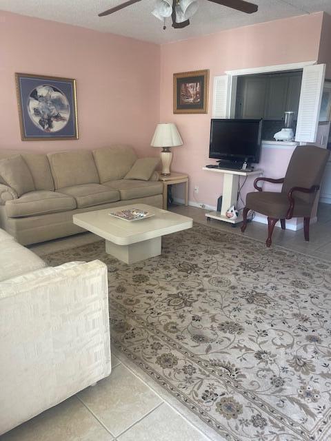577 Mansfield N N Unit 577, Boca Raton, FL 33434 - living room featuring ceiling fan, light tile patterned floors, and baseboards