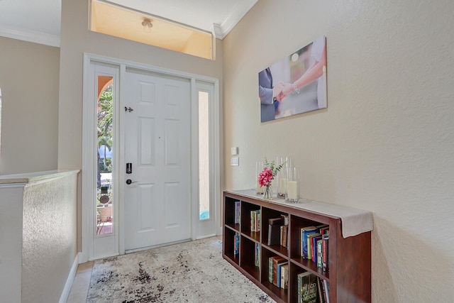146 Magnolia Way, Tequesta, FL 33469 - foyer entrance featuring ornamental molding, a textured wall, and baseboards