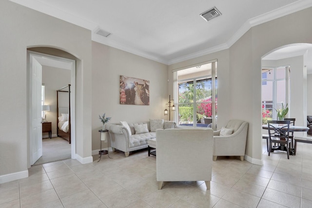 146 Magnolia Way, Tequesta, FL 33469 - living area featuring arched walkways, ornamental molding, light tile patterned floors, and baseboards