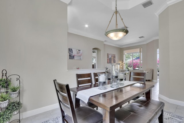 146 Magnolia Way, Tequesta, FL 33469 - dining area with arched walkways, crown molding, light tile patterned floors, baseboards, and recessed lighting