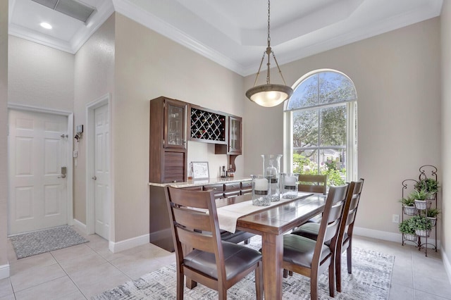 146 Magnolia Way, Tequesta, FL 33469 - dining room featuring a high ceiling, light tile patterned floors, baseboards, ornamental molding, and bar