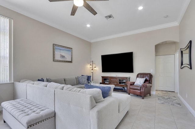 146 Magnolia Way, Tequesta, FL 33469 - living area featuring arched walkways, ceiling fan, crown molding, light tile patterned floors, and baseboards