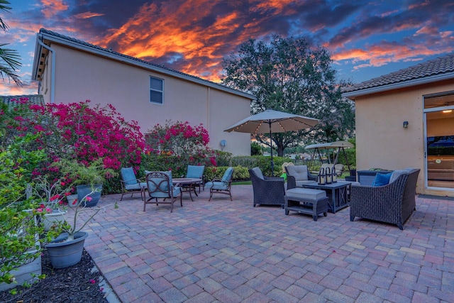 146 Magnolia Way, Tequesta, FL 33469 - patio terrace at dusk featuring a patio area and an outdoor living space