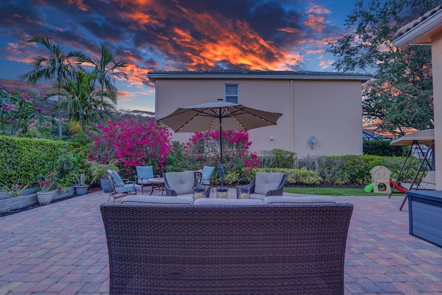 146 Magnolia Way, Tequesta, FL 33469 - patio terrace at dusk with a patio area and an outdoor living space