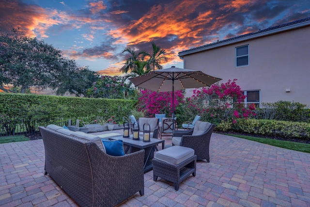 146 Magnolia Way, Tequesta, FL 33469 - patio terrace at dusk with an outdoor living space and a patio