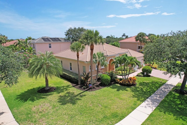146 Magnolia Way, Tequesta, FL 33469 - mediterranean / spanish-style house with a front yard, a tiled roof, and stucco siding
