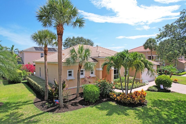 146 Magnolia Way, Tequesta, FL 33469 - view of front of house with a front yard, stucco siding, and a tile roof