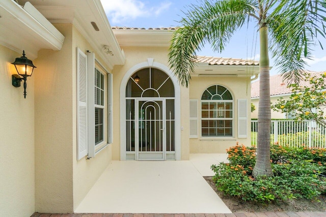 843 Niemen Dr, Palm Beach Gardens, FL 33410 - entrance to property featuring stucco siding and a tiled roof