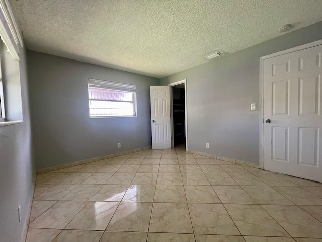 4491 NW 1st Ter, Deerfield Beach, FL 33064 - unfurnished bedroom with a textured ceiling