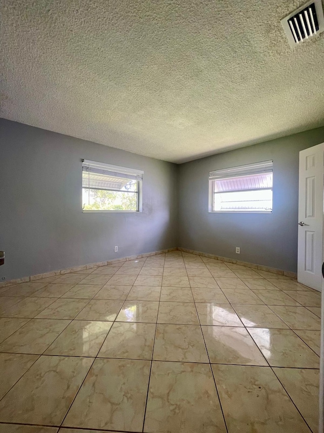 4491 NW 1st Ter, Deerfield Beach, FL 33064 - empty room with a textured ceiling