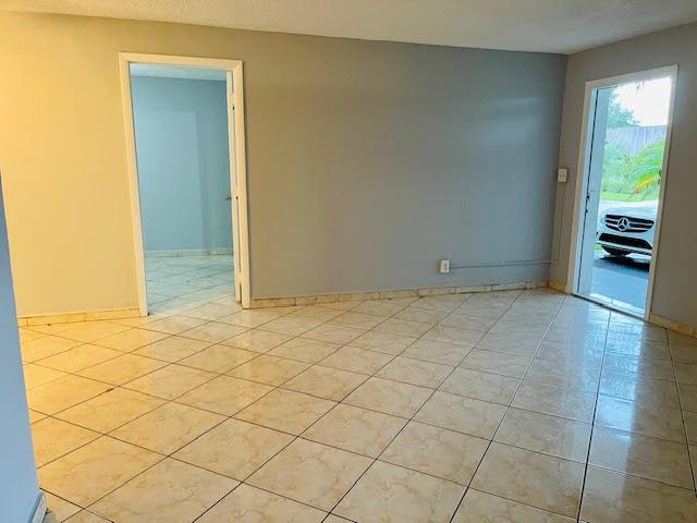 4491 NW 1st Ter, Deerfield Beach, FL 33064 - unfurnished room with light tile patterned floors and baseboards