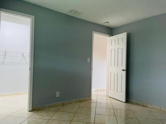 4491 NW 1st Ter, Deerfield Beach, FL 33064 - unfurnished bedroom featuring light tile patterned flooring and baseboards