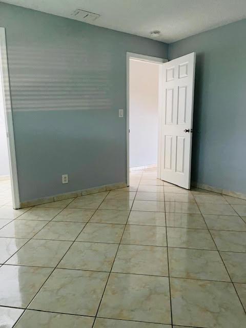 4491 NW 1st Ter, Deerfield Beach, FL 33064 - spare room with light tile patterned floors