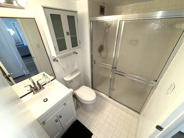 2860 S Ocean Blvd Unit 415, Palm Beach, FL 33480 - bathroom featuring vanity, a stall shower, toilet, and tile patterned floors