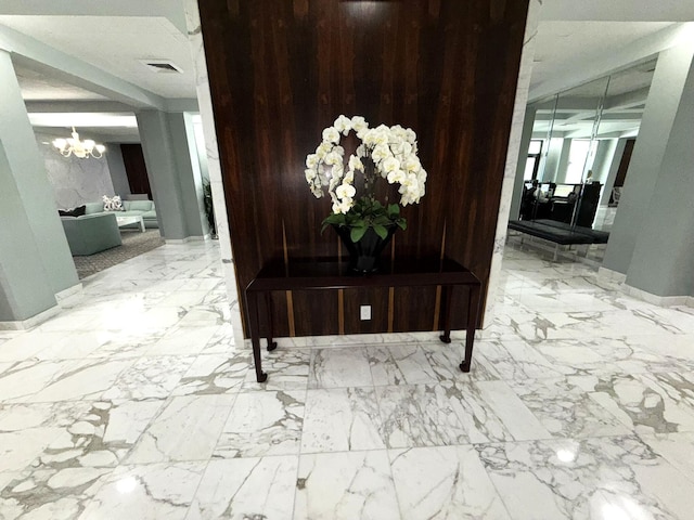 2860 S Ocean Blvd Unit 415, Palm Beach, FL 33480 - hall featuring a chandelier and marble finish flooring