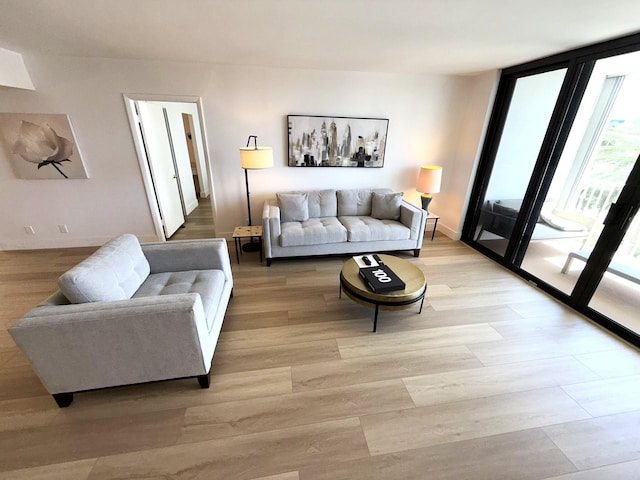2860 S Ocean Blvd Unit 415, Palm Beach, FL 33480 - living area with light wood-style floors, floor to ceiling windows, and baseboards