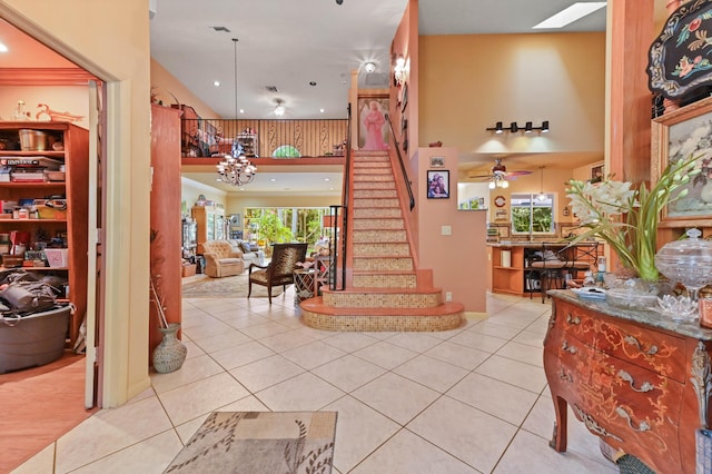 6935 Pioneer Rd, West Palm Beach, FL 33413 - stairs with tile patterned floors, a ceiling fan, recessed lighting, and a chandelier