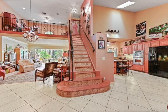6935 Pioneer Rd, West Palm Beach, FL 33413 - stairs with tile patterned flooring, recessed lighting, a high ceiling, and a chandelier