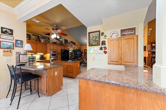 6935 Pioneer Rd, West Palm Beach, FL 33413 - kitchen with a peninsula, stainless steel double oven, a ceiling fan, light tile patterned floors, and stone counters
