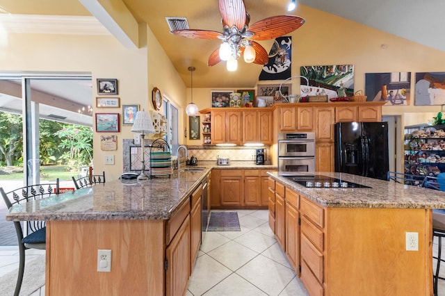 6935 Pioneer Rd, West Palm Beach, FL 33413 - kitchen featuring black appliances, a kitchen breakfast bar, lofted ceiling, decorative backsplash, and light tile patterned floors