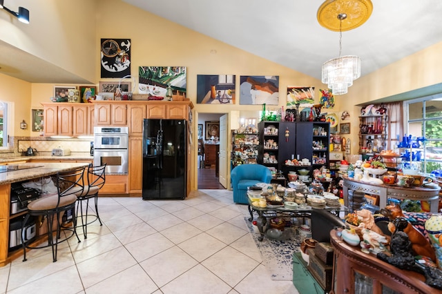 6935 Pioneer Rd, West Palm Beach, FL 33413 - dining space featuring light tile patterned flooring, a chandelier, and high vaulted ceiling