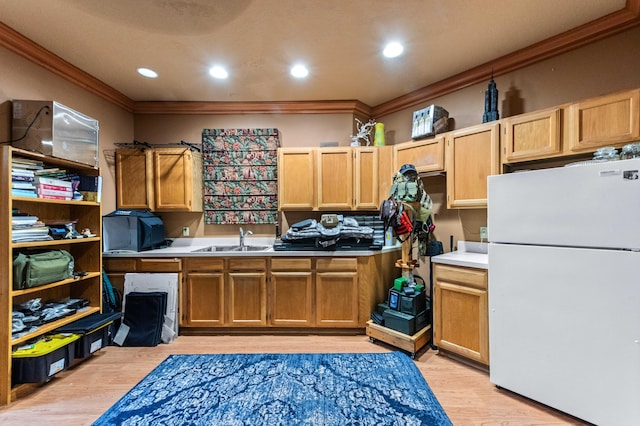 6935 Pioneer Rd, West Palm Beach, FL 33413 - kitchen featuring freestanding refrigerator, crown molding, light wood-style floors, light countertops, and light brown cabinets