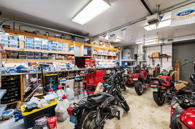 6935 Pioneer Rd, West Palm Beach, FL 33413 - garage with a workshop area and a garage door opener