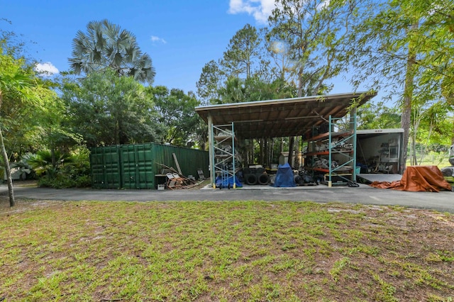 6935 Pioneer Rd, West Palm Beach, FL 33413 - view of yard with an outbuilding, a carport, and an outdoor structure