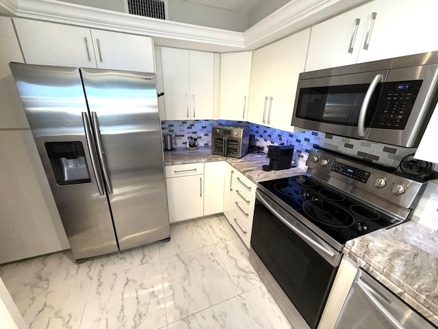 2425 Presidential Way Unit 1804, West Palm Beach, FL 33401 - kitchen featuring stainless steel appliances, light marble finish flooring, backsplash, and white cabinets