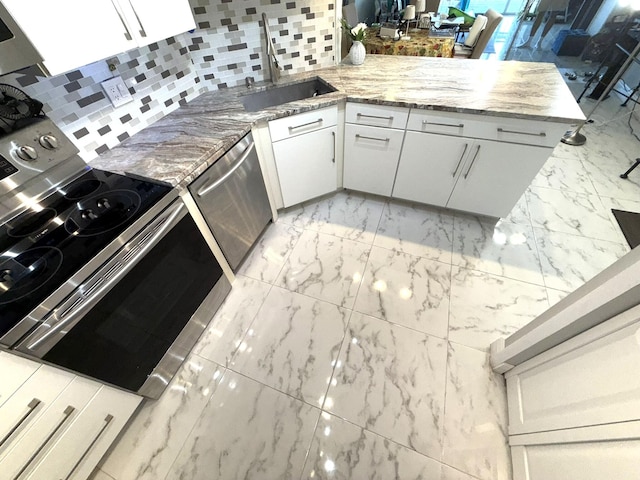 2425 Presidential Way Unit 1804, West Palm Beach, FL 33401 - kitchen with stainless steel appliances, a sink, light marble finish flooring, white cabinets, and decorative backsplash