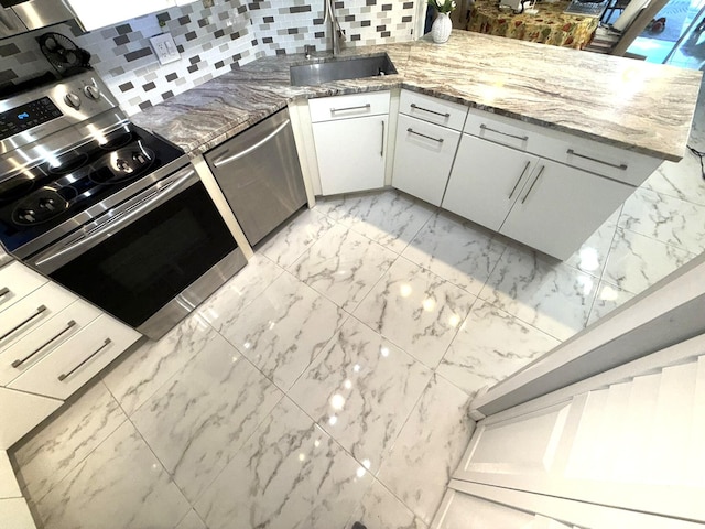 2425 Presidential Way Unit 1804, West Palm Beach, FL 33401 - kitchen with a sink, stainless steel appliances, light marble finish floors, and decorative backsplash
