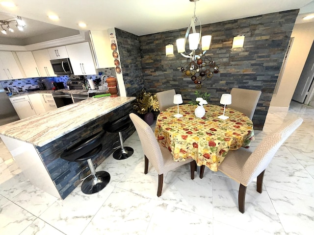 2425 Presidential Way Unit 1804, West Palm Beach, FL 33401 - dining room featuring light marble finish floors, a chandelier, and recessed lighting