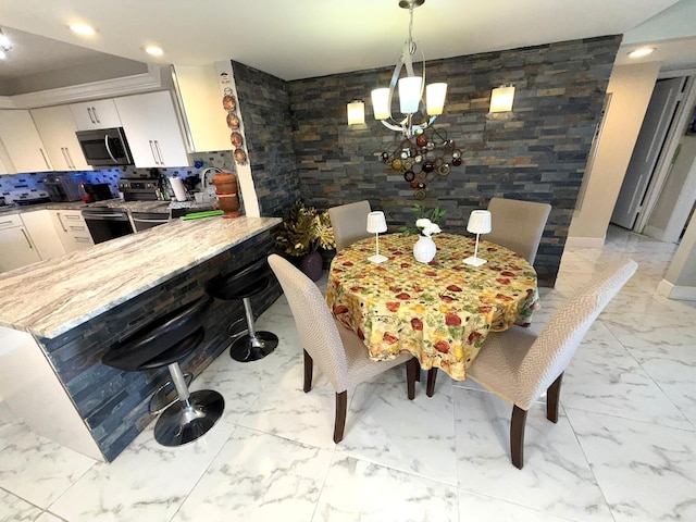 2425 Presidential Way Unit 1804, West Palm Beach, FL 33401 - dining space featuring light marble finish floors, a chandelier, and recessed lighting